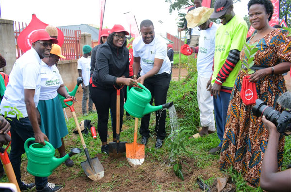 Absa’s Helen Basuuta Nangonzi the Hoima City Mayor Brian Kaboyo at the tree planting launch in Hoima